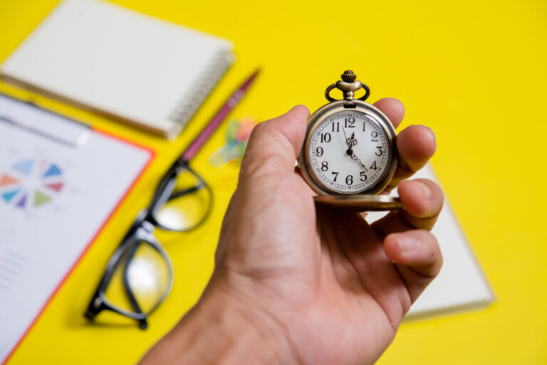 Close up hand holding clock, business concept